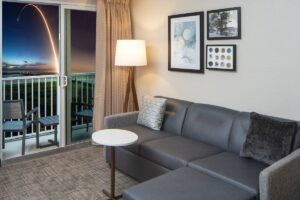 Hotel living room with view of SpaceX rocket launch out the sliding glass door from the Cape Canaveral Marriot Residence Inn Hotel.