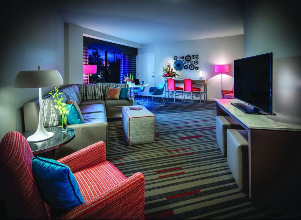 Stylish interior of a modern suite at Hard Rock Hotel Orlando with vibrant decor and a tropical view, a favorite Universal Studio Hotels in Orlando, Florida.