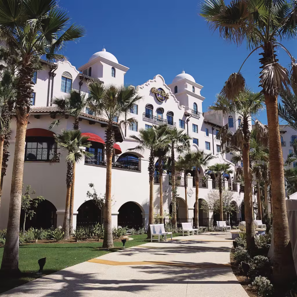 Hard Rock Hotel Orlando exterior, a premier hotel near Universal Studios in Orlando, Florida, showcasing Spanish-style architecture and lush palm landscaping.