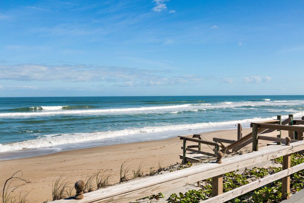 Scenic view of Melbourne Beach with wooden boardwalk and sandy shore