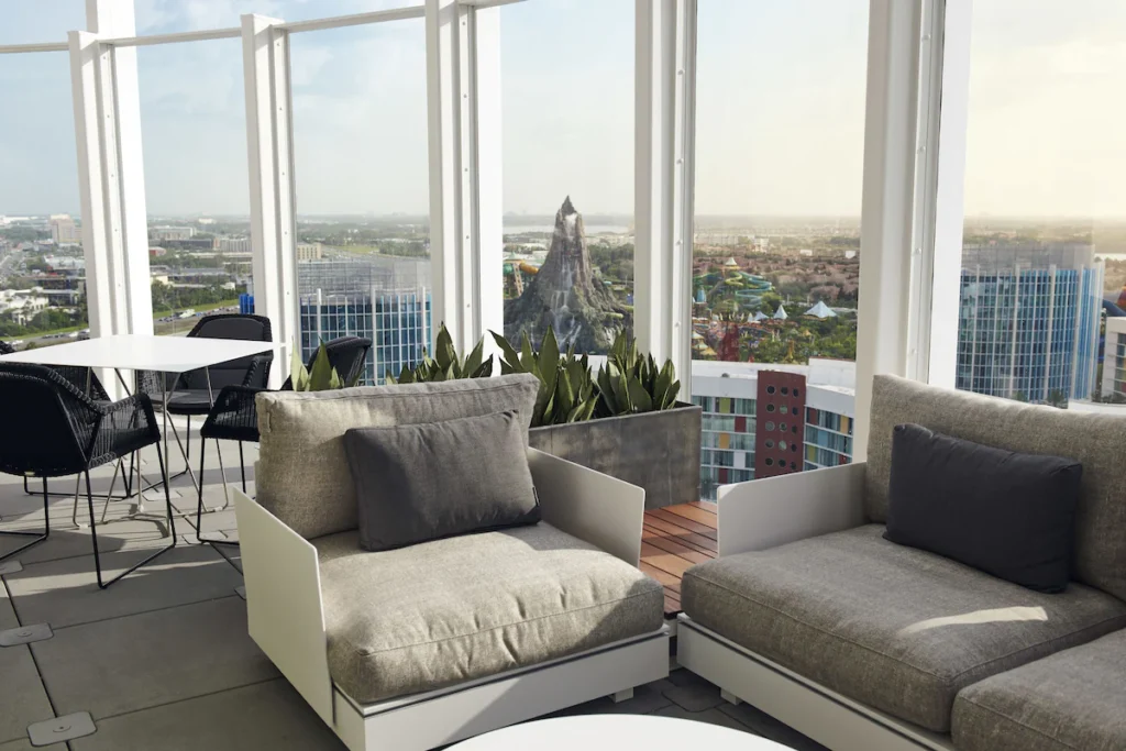 Modern, chic guest room at Universal’s Aventura Hotel, Orlando, showcasing minimalist design with comfortable bedding, sleek furnishings, and a view of the resort, perfect for a stylish and convenient stay near Universal Studios.