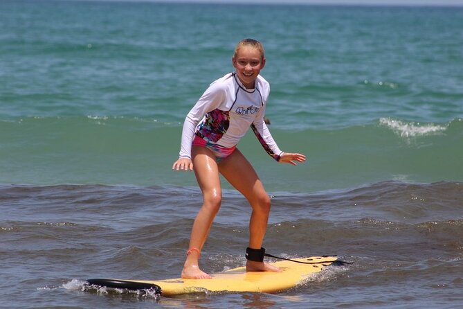 Girl surfing on a sunny day at Cocoa Beach.