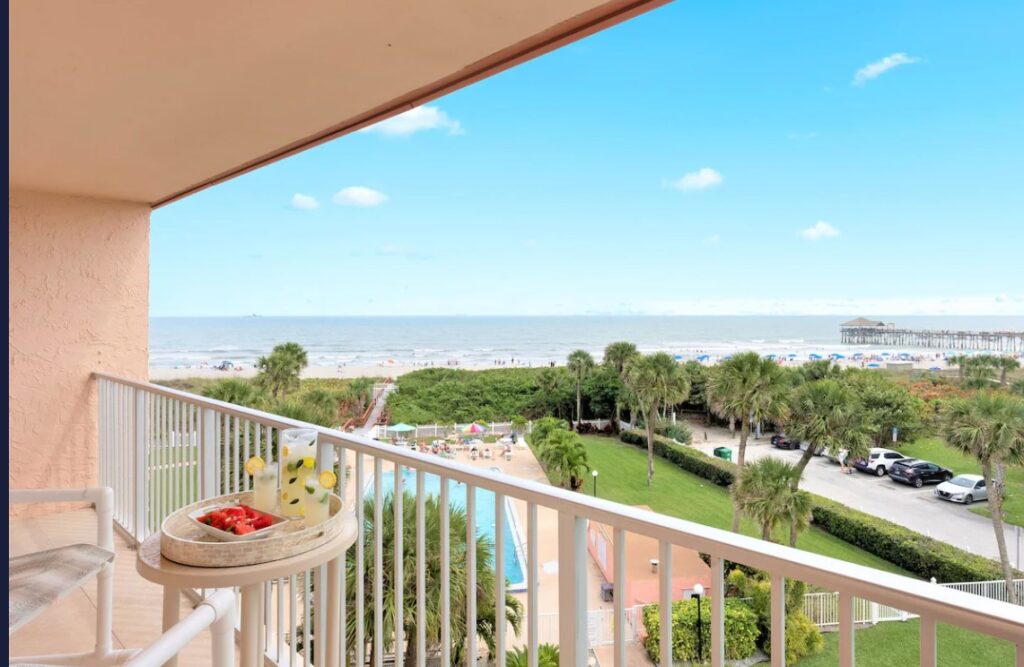 Cocoa Beach penthouse vacation home with ocean view, pool, and patio seating.