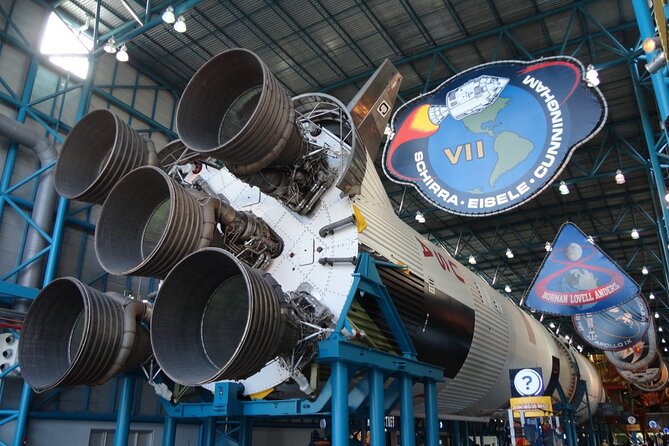 View of the Kennedy Space Center with rockets and the iconic Vehicle Assembly Building in the background.