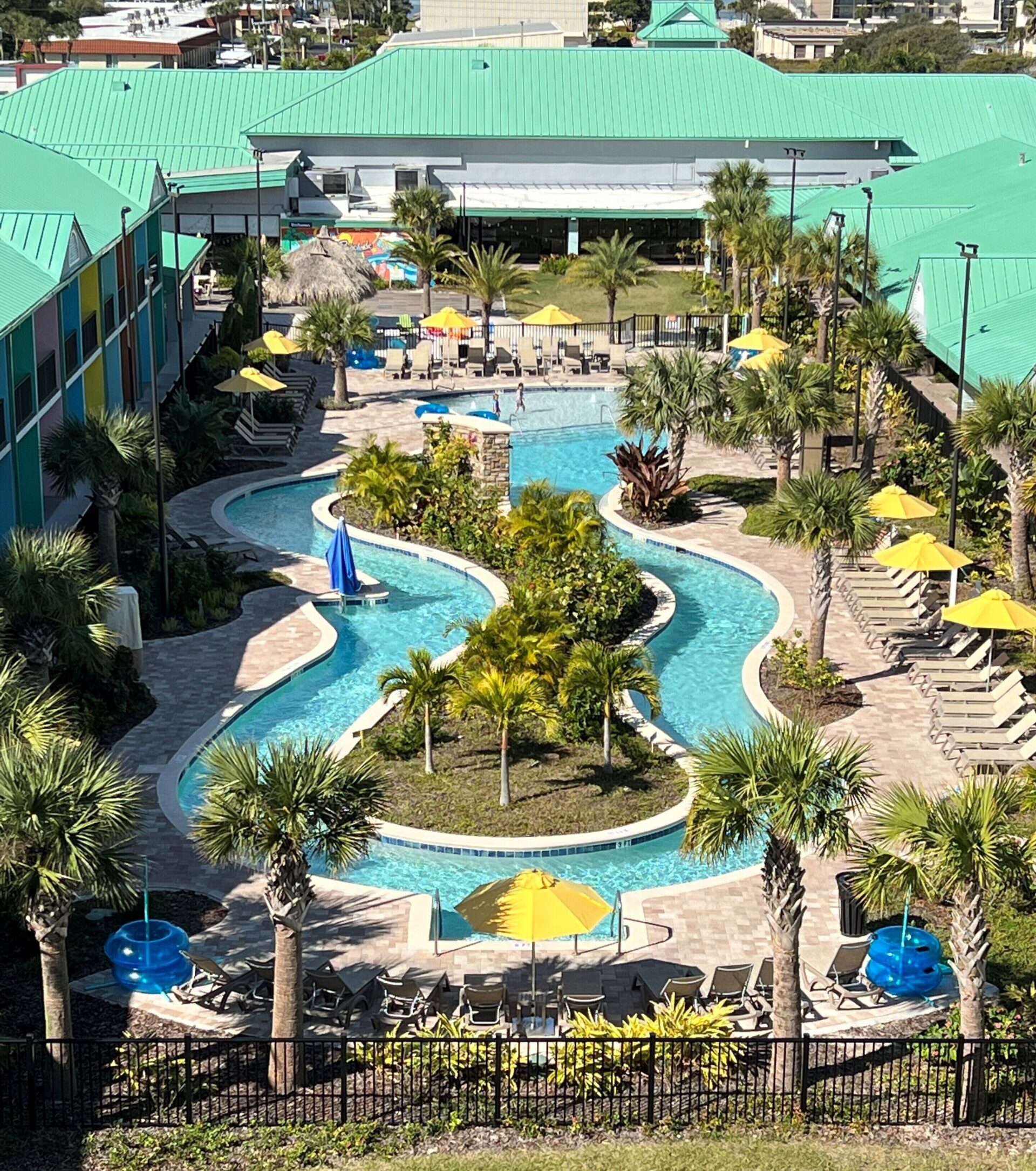 Exterior of Beachside Hotel & Suites in Cocoa Beach featuring retro-style design and lazy river pool