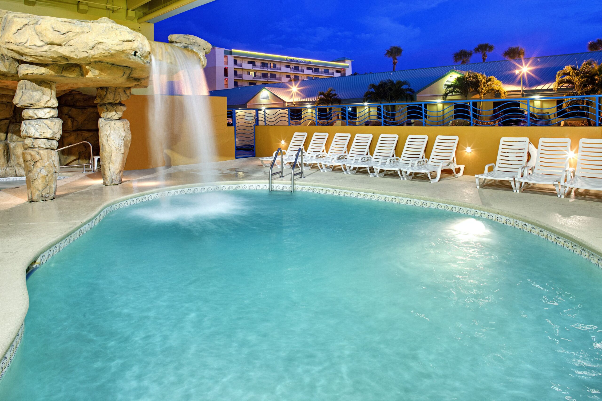 Image of outdoor pool with waterfall at Four Point Sheraton Cocoa Beach resort.