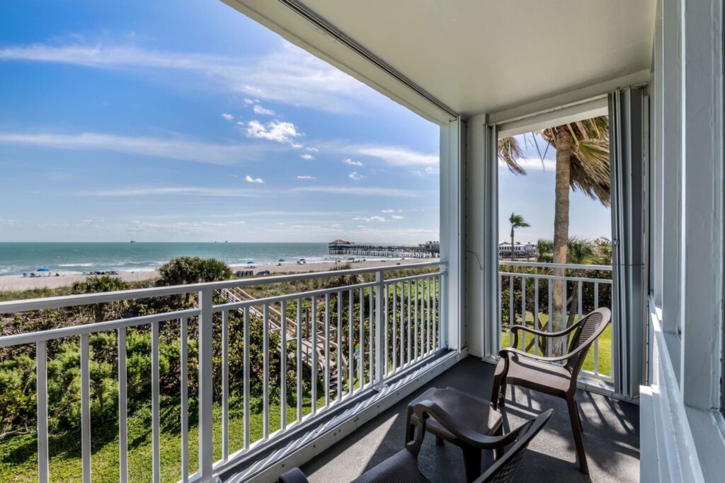 Oceanfront balcony view from a pet friendly suite at Best Western Cocoa Beach Hotel & Suites, overlooking the beach and Cocoa Beach Pier.