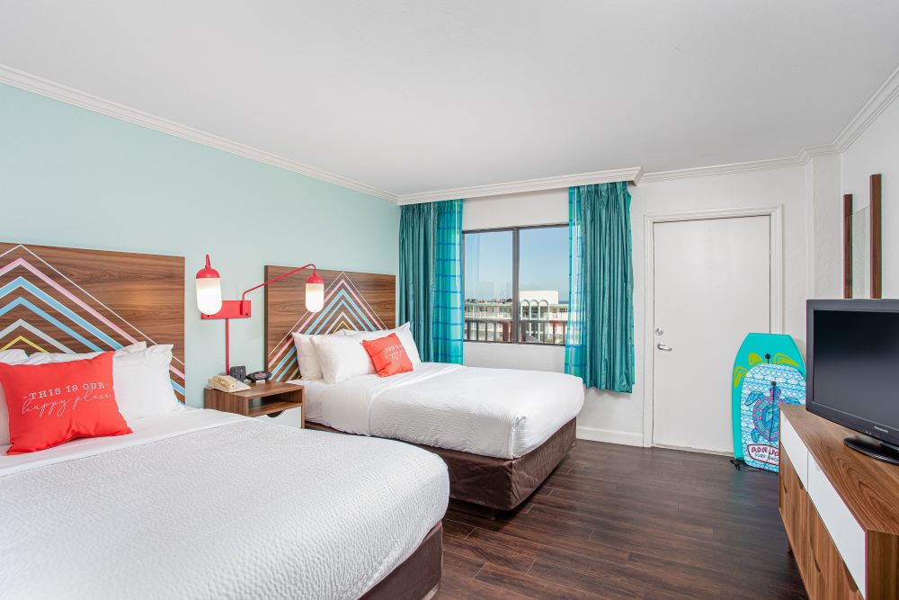 Spacious guest room with modern furnishings at Beachside Hotel Cocoa Beach.