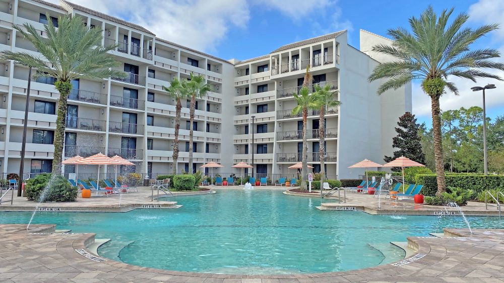 View of exterior of Holiday Inn Orlando near Disney Springs and it's pool