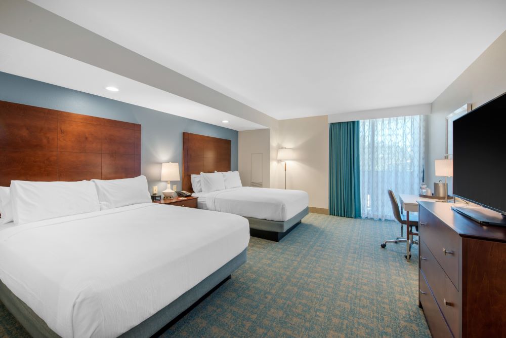 Holiday Inn Orlando - Disney Springs guest room featuring two queen beds.