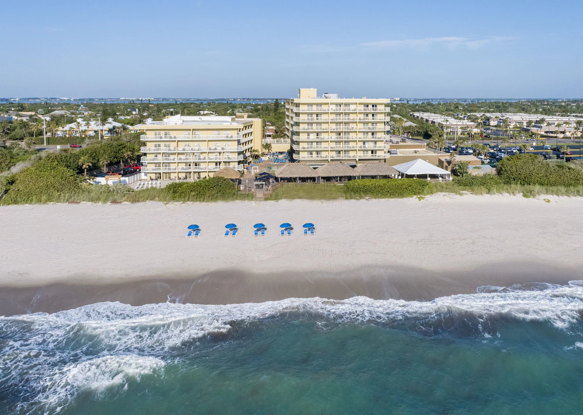 Crowne Plaza Melbourne Oceanfront hotel with direct beach access and oceanfront seating.