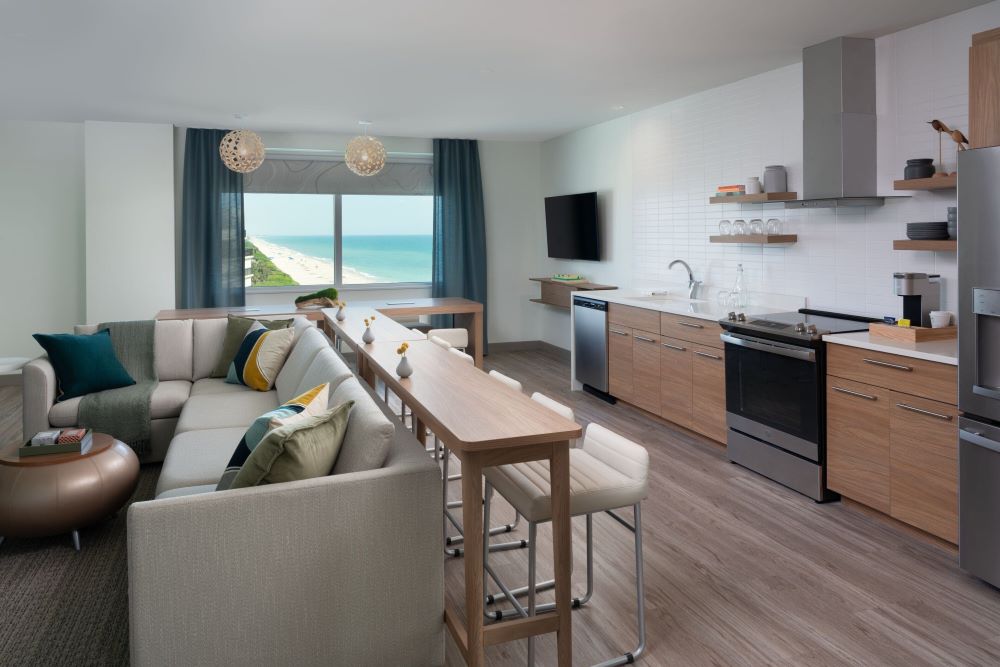 Modern living area and kitchen in a suite at Element Melbourne Oceanfront.