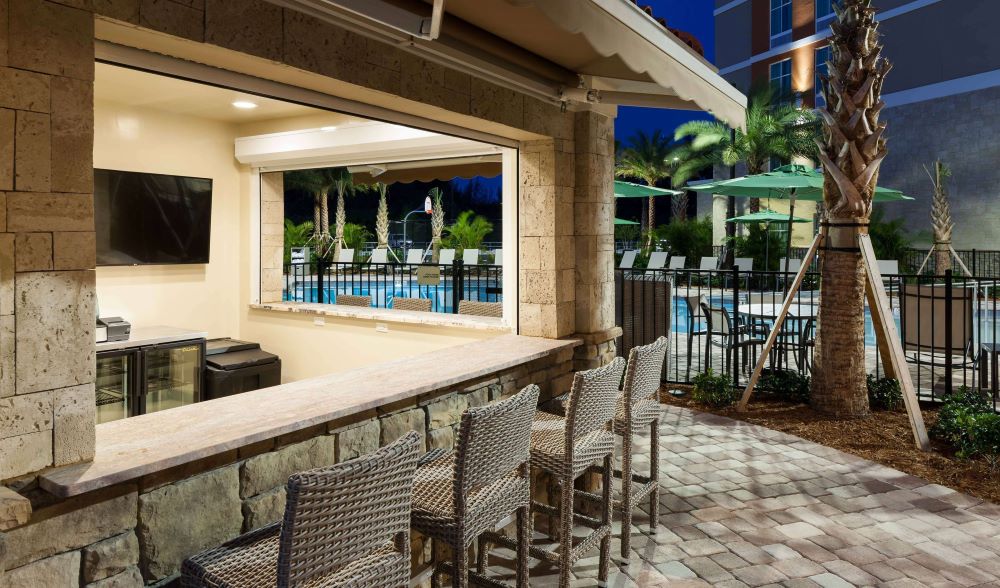 Image of the bar next to the outdoor pool at Homewood Suites in Cape Canaveral, which is often at the top of the list of great beach resorts in Florida