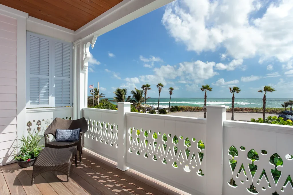 Balcony view with palm trees and ocean in the background at Port d'Hiver, known as one of the best beach resorts in Florida