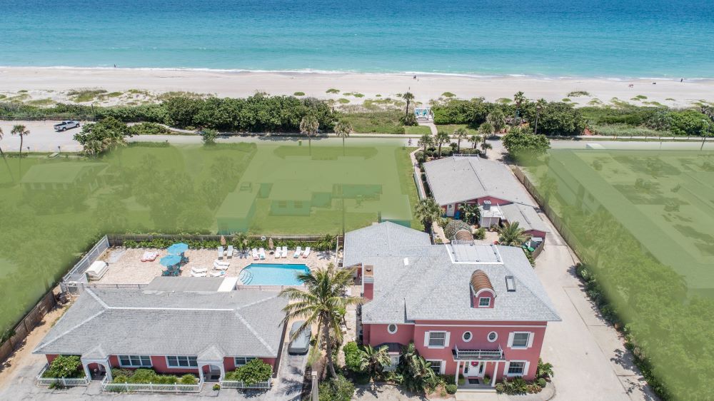 Aerial view of Windermere Inn by the Sea showcasing the property layout, pool area, and proximity to the beach.