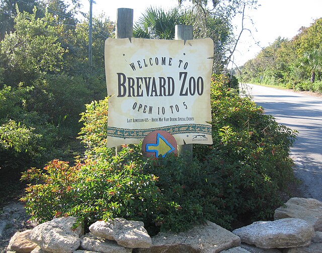 Entrance sign at Brevard Zoo, one of the top Space Coast attractions, featuring lush greenery and welcoming signage.