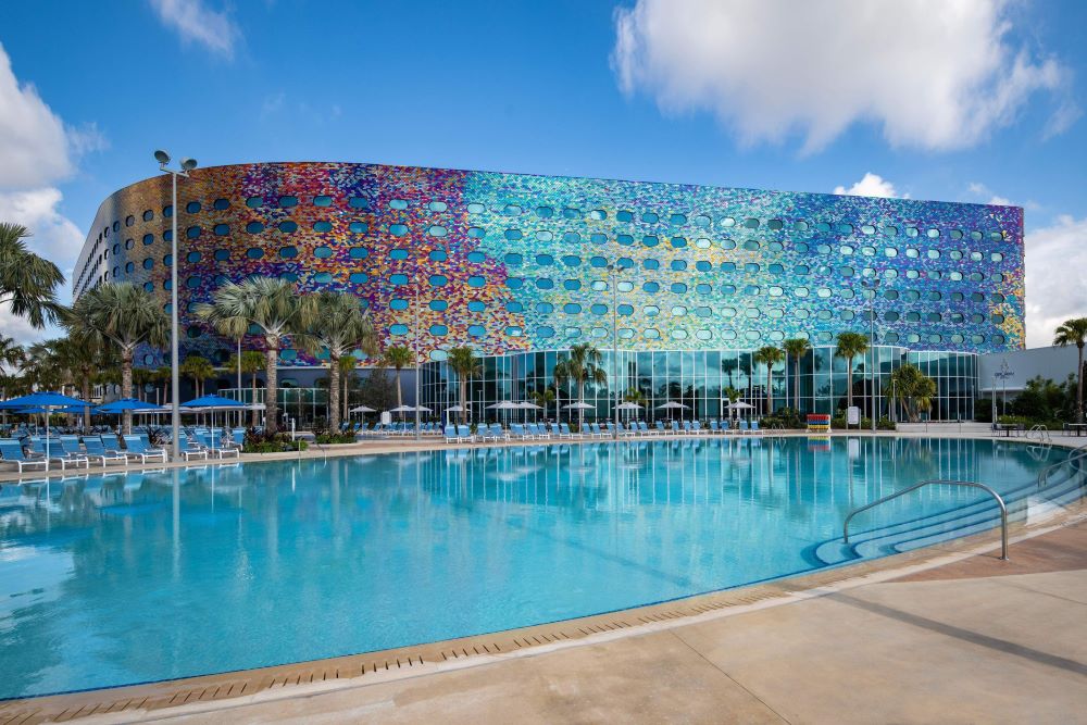 Exterior view of Universal Stella Nova Resort near Epic Universe Orlando, featuring cosmic-inspired modern architecture and palm-lined entrance